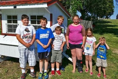 A customer's grandchildren enjoying their 5x6 chicken coop