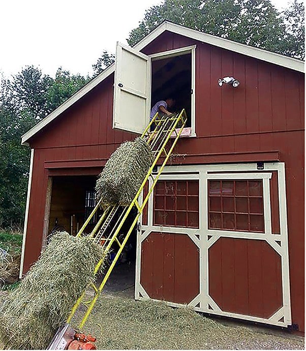 loading hay bails in barn