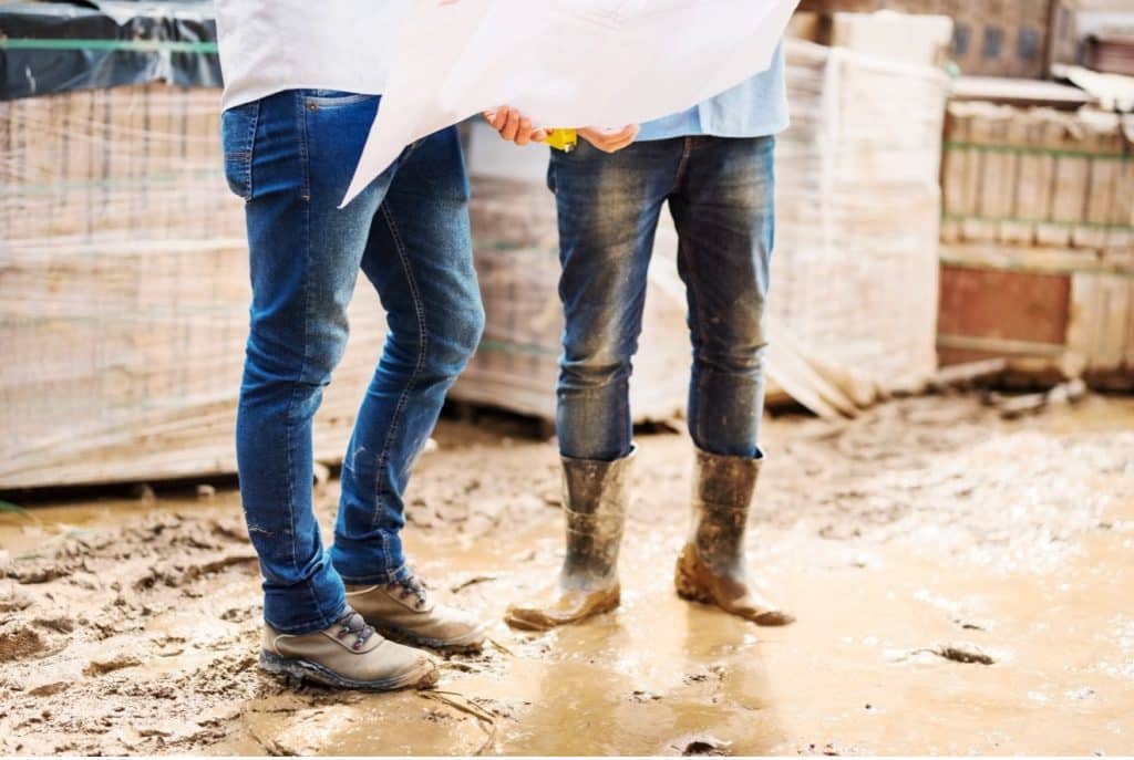 people standing in mud